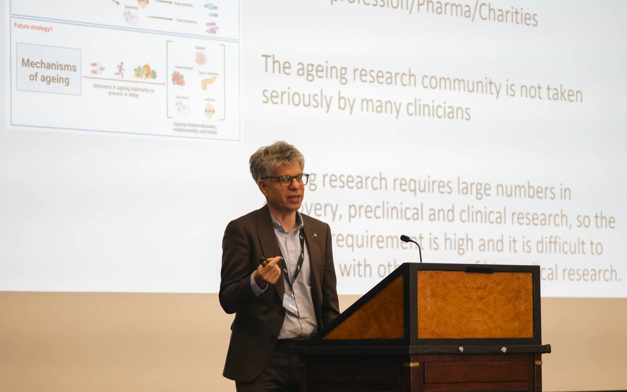 A scientific presentation discussing challenges in aging research