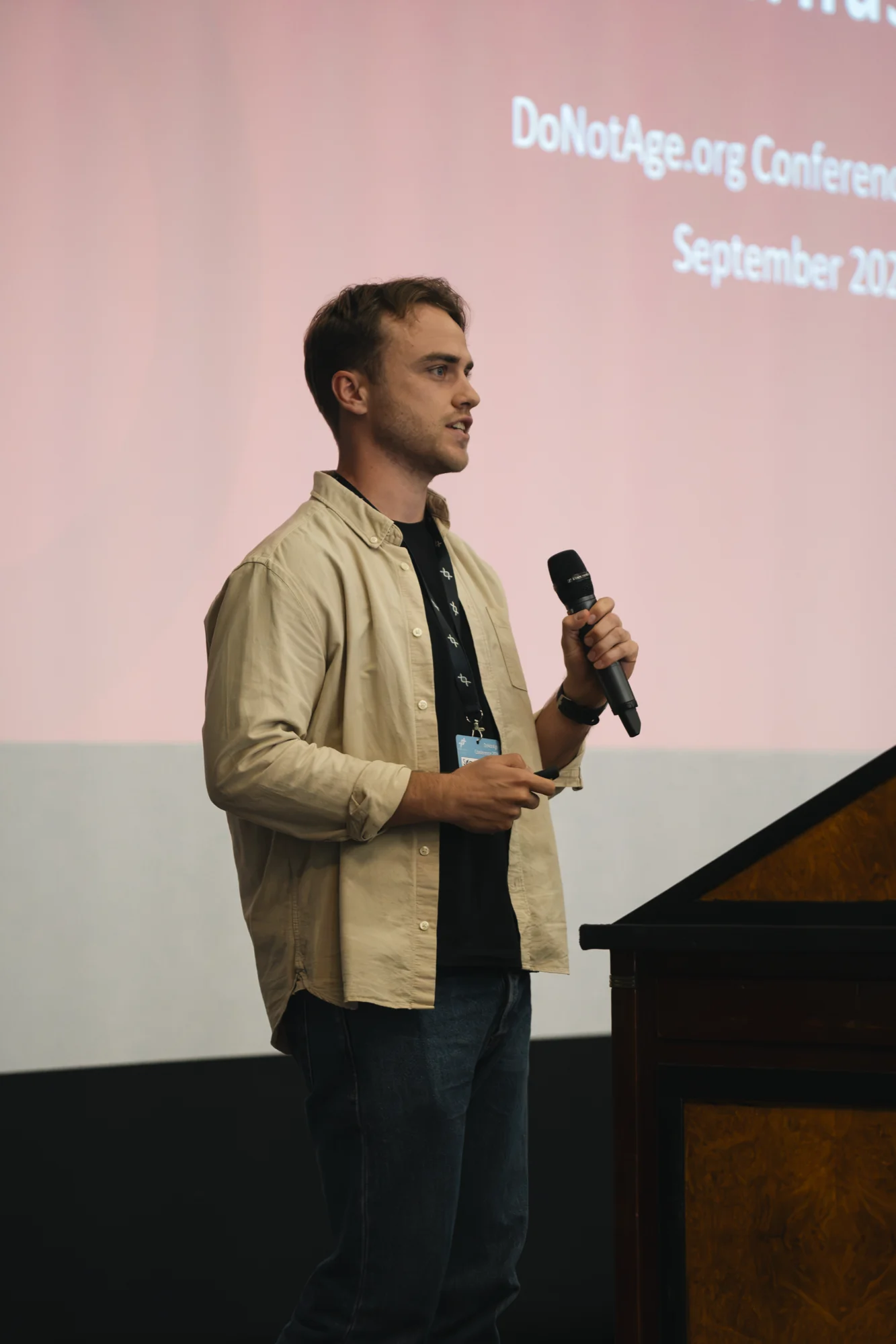 A conference presenter speaking with a handheld microphone